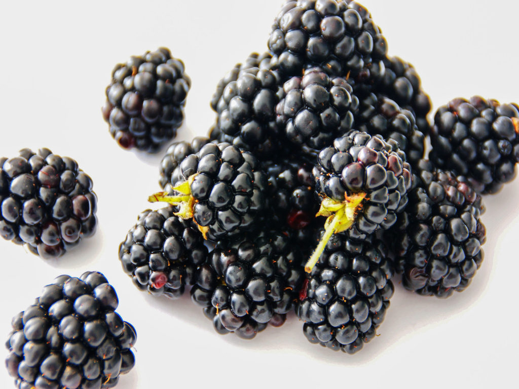 Closeup picture of blackberries on a plate.